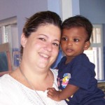 Smiling woman holding young child