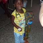 Smiling child with stethoscope and colorful cloth