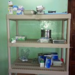 Beige plastic shelving with toiletries and supplies