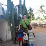 Woman with four children beside tall cactus