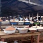 Metal bowls of grains at outdoor market